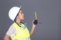 Asian Architect Engineer woman in white hard hat, safety vast, p Royalty Free Stock Photo