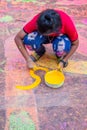 Asian artist painting color on street in the festival