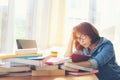 Asian asian women reading something in a book and taking notes at college library. Royalty Free Stock Photo