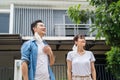 Asian attractive couple standing in front of their house and take deep breathing after removing protective face mask. Beautiful ma