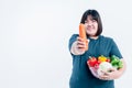 Asian attractive fat woman showing and holding glass bowl  contains fruit and fresh vegetables Royalty Free Stock Photo