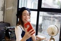 Asian attractive and stylish girl eating ice cream and taking a selfie photo shot