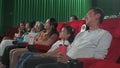 An Asian audience enjoys watching cinema together at movie theaters.