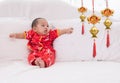 Asian baby boy Chinese Cheongsam costume toddler lie down on bed at home smiling laughing good humored infant Chinese boy laugh