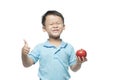 Asian baby boy holding and eating red apple, isolated on white Royalty Free Stock Photo