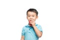 Asian baby boy holding and eating red apple, isolated on white Royalty Free Stock Photo