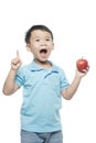 Asian baby boy holding and eating red apple, isolated on white Royalty Free Stock Photo