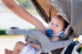 Asian Baby Boy Hydrating with a Straw from Blue Bottle, staying hydrated on a warm day outdoors. Royalty Free Stock Photo