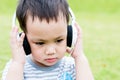 The Asian baby boy listening music by headphone Royalty Free Stock Photo