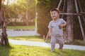 Asian baby boy running in the garden during the evening, Royalty Free Stock Photo