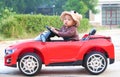 Asian baby boy siting on Toy car