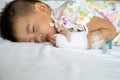 Asian baby boy sleeping on bed with infusion set at child department in the hospital. Royalty Free Stock Photo
