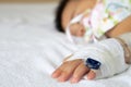 Asian baby boy sleeping on bed with infusion set at child department in the hospital. Royalty Free Stock Photo