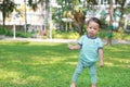 Asian baby boy walking first step on green grass garden Royalty Free Stock Photo