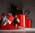 Asian baby child kid girl sitting in red santa hat with big christmas Royalty Free Stock Photo