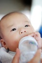 Asian baby is drinking milk Royalty Free Stock Photo