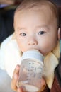 Asian baby is drinking milk Royalty Free Stock Photo