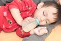 Asian baby drinking milk from bottle Royalty Free Stock Photo