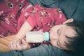 Asian baby drinking milk from bottle Royalty Free Stock Photo