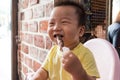 Asian cute baby eating grilled lamb meat & x28;should rack Royalty Free Stock Photo