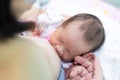 Asian baby feeding on her mother`s breast. soft focus Royalty Free Stock Photo