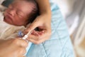 Asian baby getting fingernails cut Royalty Free Stock Photo