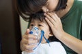 Asian baby girl breathing treatment with mother take care, at room hospital.