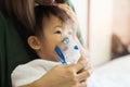 Asian baby girl breathing treatment with mother take care, at room hospital.