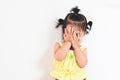 Asian baby girl closing her face and playing peekaboo or hide and seek with fun