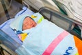 Asian baby girl with cute face Sleep well and cover the blue blanket in the hospital room. While her mother was resting after she Royalty Free Stock Photo