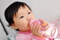 A Asian baby girl drinking water Royalty Free Stock Photo