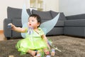 Asian baby girl with halloween party dressing and play toy block Royalty Free Stock Photo