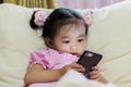 Asian baby girl looking at smart phone