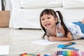 Asian baby girl Lying on the floor,  are concentrating make art Royalty Free Stock Photo