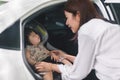 Asian baby girl sleeping in car seat chair, Mother preparing kid for a trip, Travel safely concept Royalty Free Stock Photo