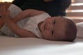 asian baby girl smiling and lying down on the bed in the bedroom after wake up in the morning Royalty Free Stock Photo