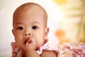 Asian baby girl sucking her thumb Royalty Free Stock Photo