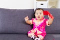 Asian baby holding red pocket with traditional chinese clothing Royalty Free Stock Photo