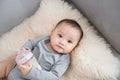 Asian baby infant eating milk from bottle, 9 months after birth Royalty Free Stock Photo