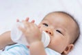 Asian baby infant enjoy drinking water from bottle Royalty Free Stock Photo