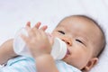 Asian baby infant enjoy drinking water from bottle Royalty Free Stock Photo