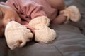 Asian baby infant wearing gloves and socks sleeping on gray bed. studio shot. Royalty Free Stock Photo