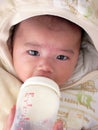 Asian baby milk feeding silently with headgear