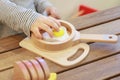 Asian baby playing with camping gear toy tools on the wooden table Royalty Free Stock Photo