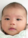 Asian baby portrait gently smiling Royalty Free Stock Photo