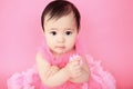 Asian baby on a studio pink background