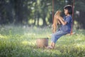 Asian baby on swing with puppy. Royalty Free Stock Photo