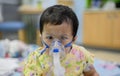 Asian baby was sick as Respiratory Syncytial Virus RSV in kid hospital. Thai little girl having inhaler containing medicine Royalty Free Stock Photo