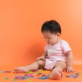 Asian baby with wooden alphabets