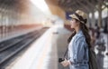 Asian backpack traveler woman with camera standing at train st Royalty Free Stock Photo